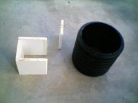 A PVC scrubber insert next to the round Pile Saver shell