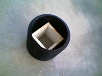 A square PVC scrubber seated inside the round shell