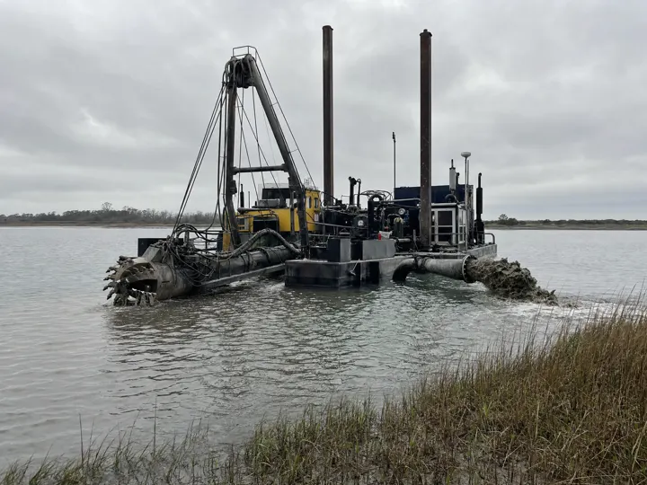 A cutter-head dredge working on a coastal waterway
